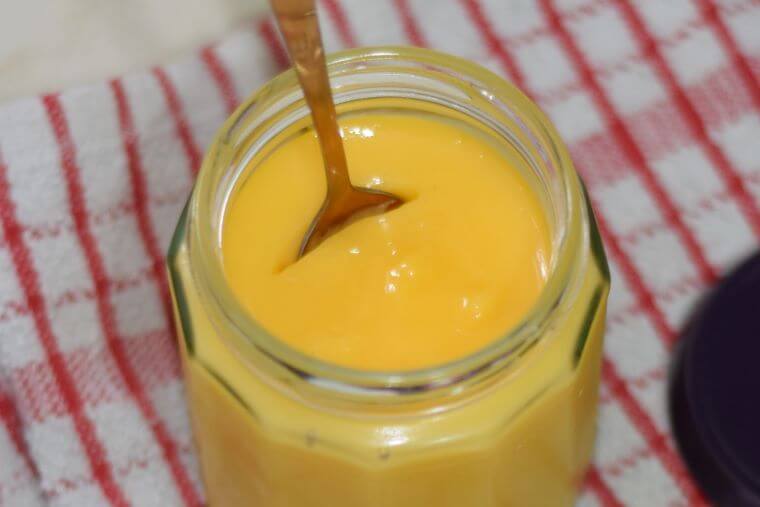 Passionfruit curd close up with spoon