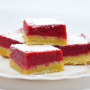 Raspberry dessert bars with a shortbread base and raspberry curd layer