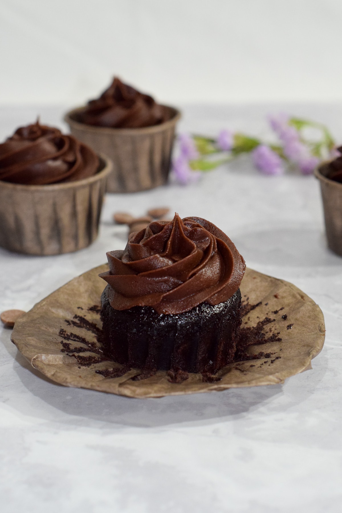 Best easy moist gluten-free chocolate cupcakes with chocolate buttercream frosting swirl opened.