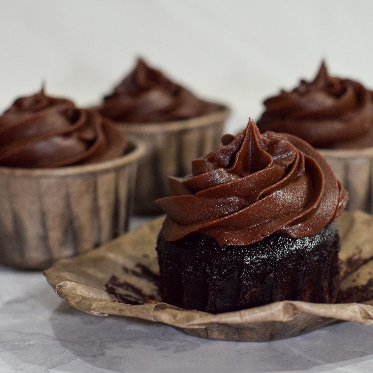 Best easy moist gluten-free chocolate cupcakes with chocolate buttercream frosting swirl opened.