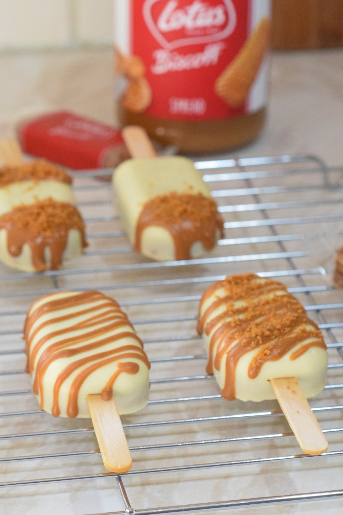 Lotus biscoff cakesicles (biscoff spread cake pop popsicles) on wire rack