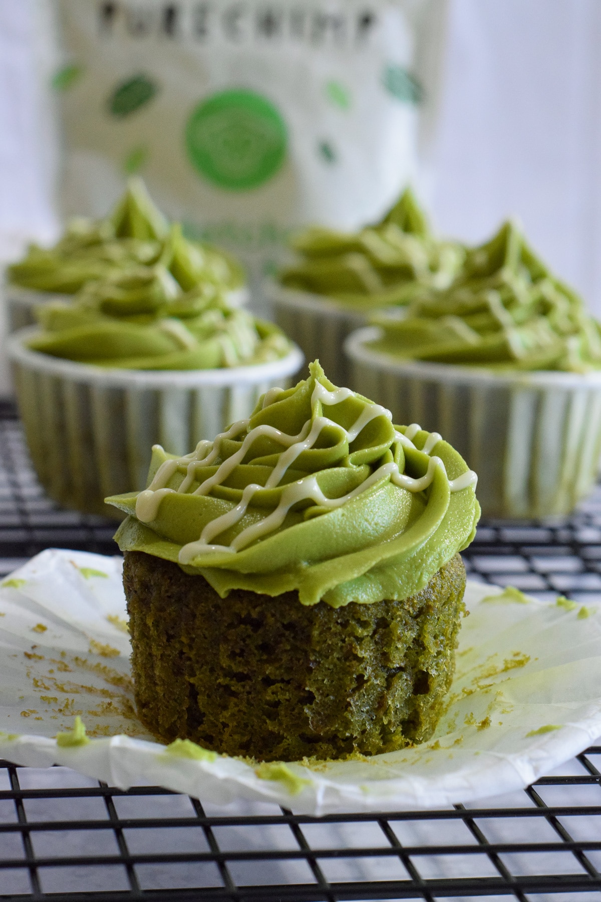 Matcha green tea cupcakes with a matcha buttercream frosting and white chocolate drizzle