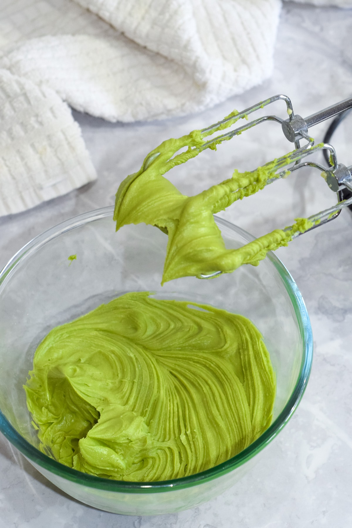 easy matcha green tea buttercream frosting on electric hand mixer