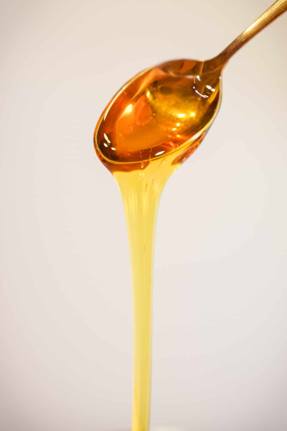 golden syrup dripping off spoon