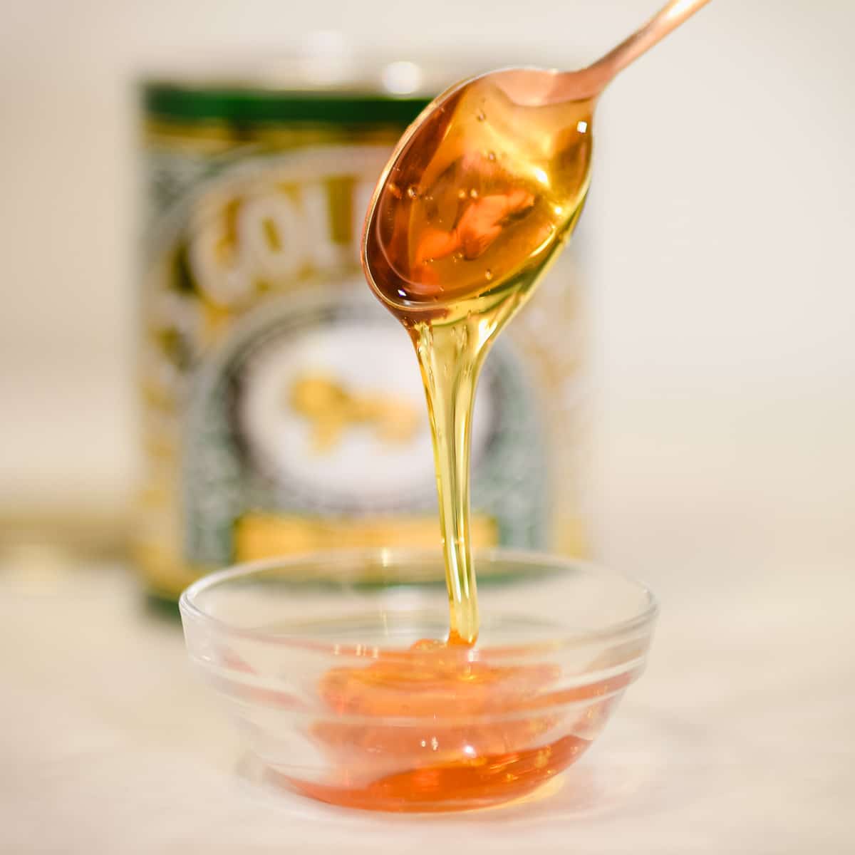 golden syrup dripping off spoon