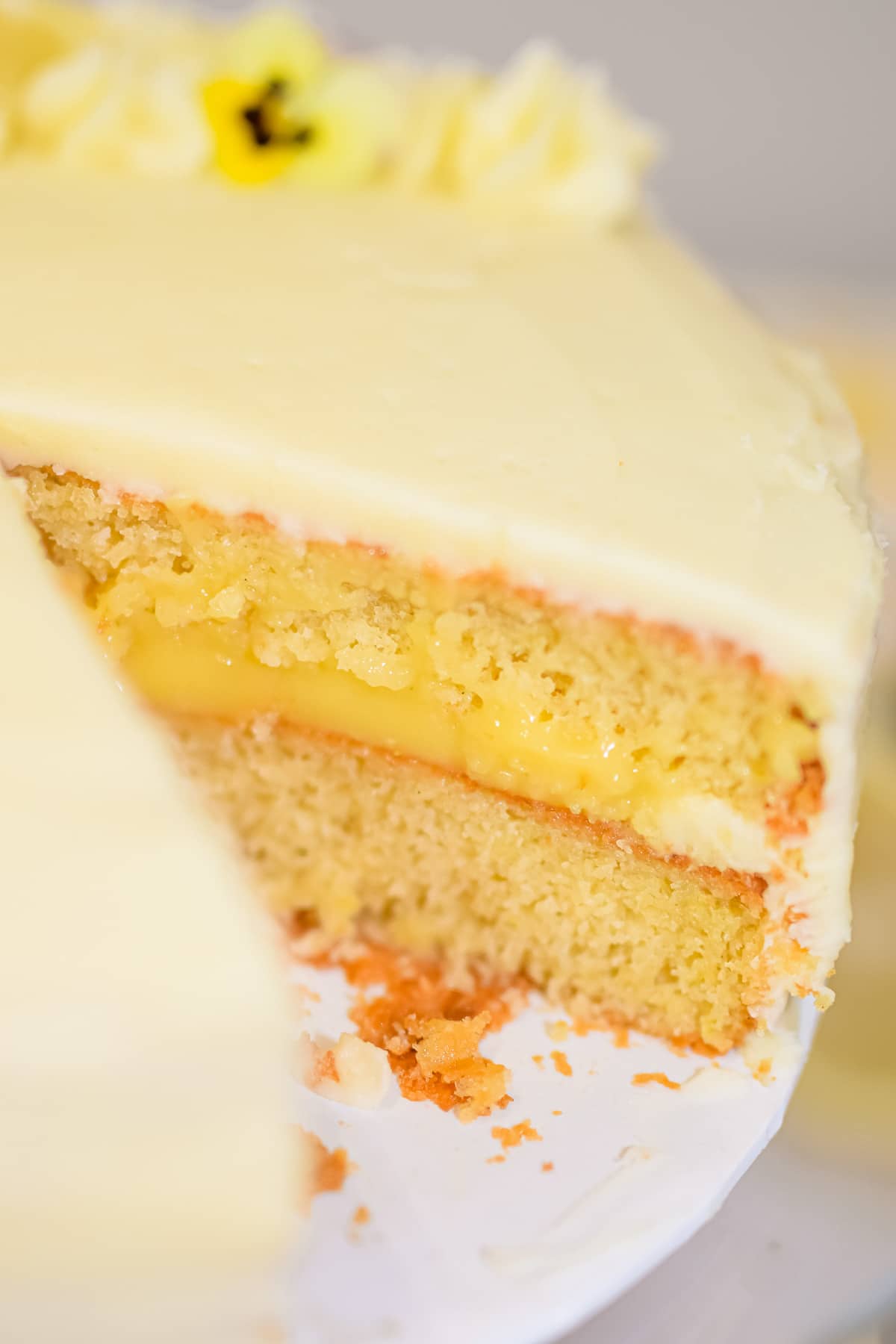 lemon curd cake filling between two layers of lemon cake