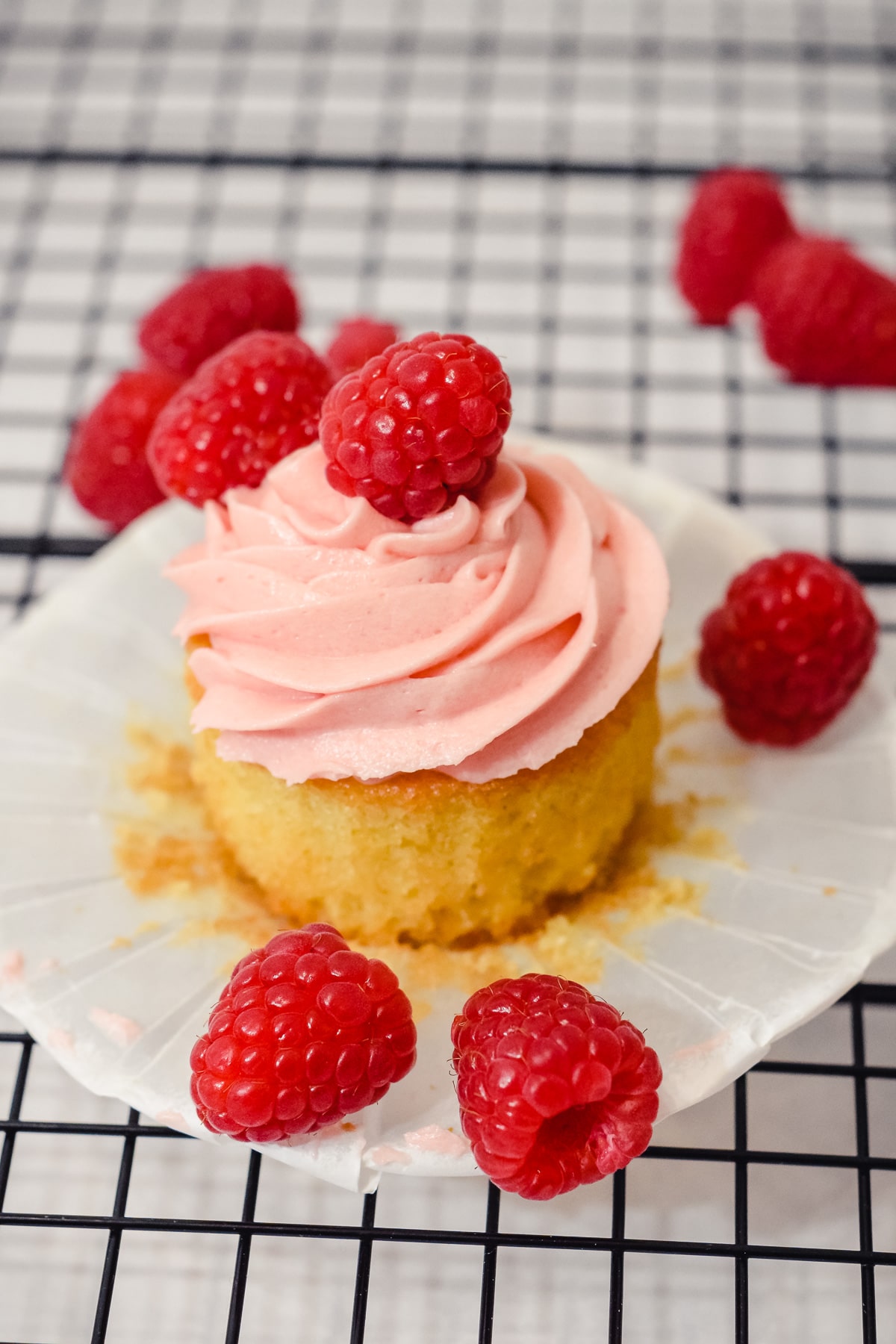 Vanilla raspberry cupcake with a vanilla sponge and fresh raspberry buttercream frosting.
