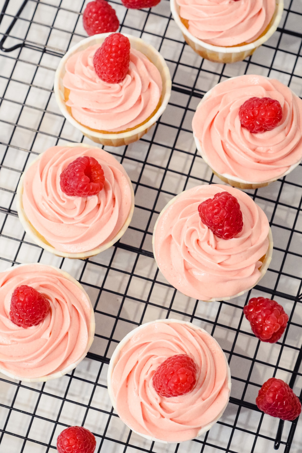 Raspberry cupcakes from above on wire rack