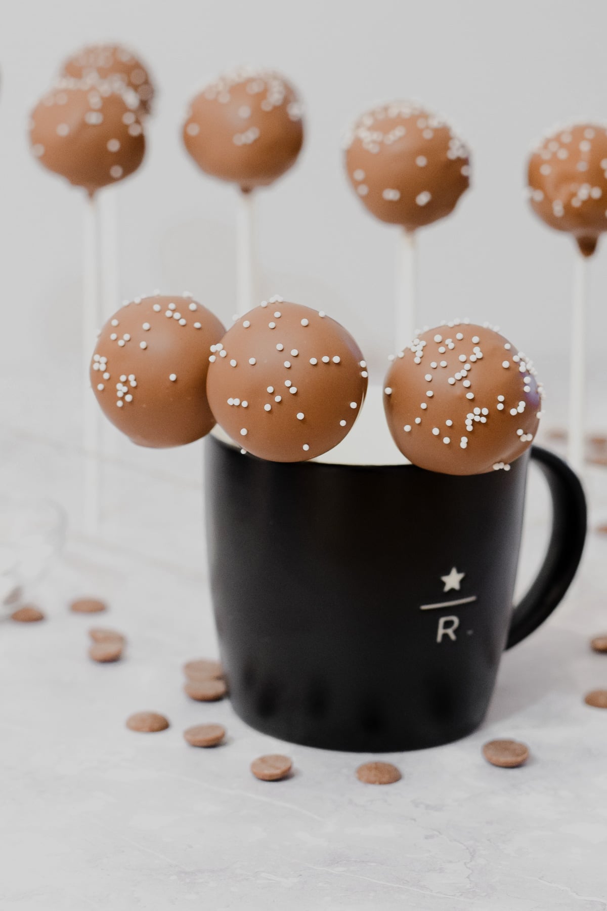 starbucks copycat chocolate coated chocolate cake pops with white sprinkles in a mug