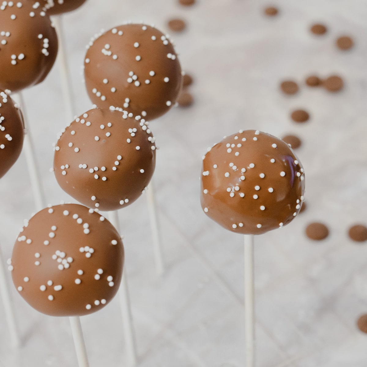 starbucks copycat chocolate coated chocolate cake pops with white sprinkles in stand