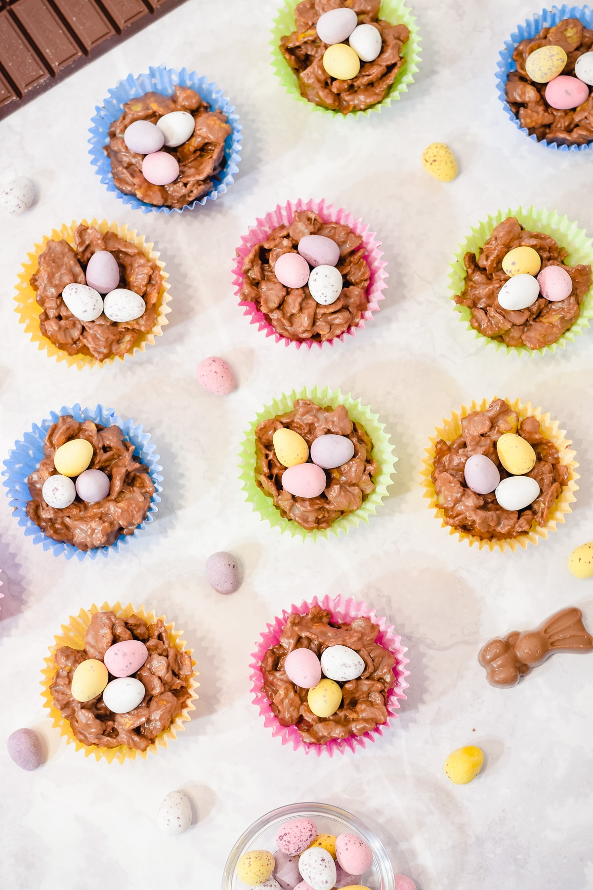 Easter chocolate cornflake nest cakes in cupcake liners topped with mini eggs with Easter decorations