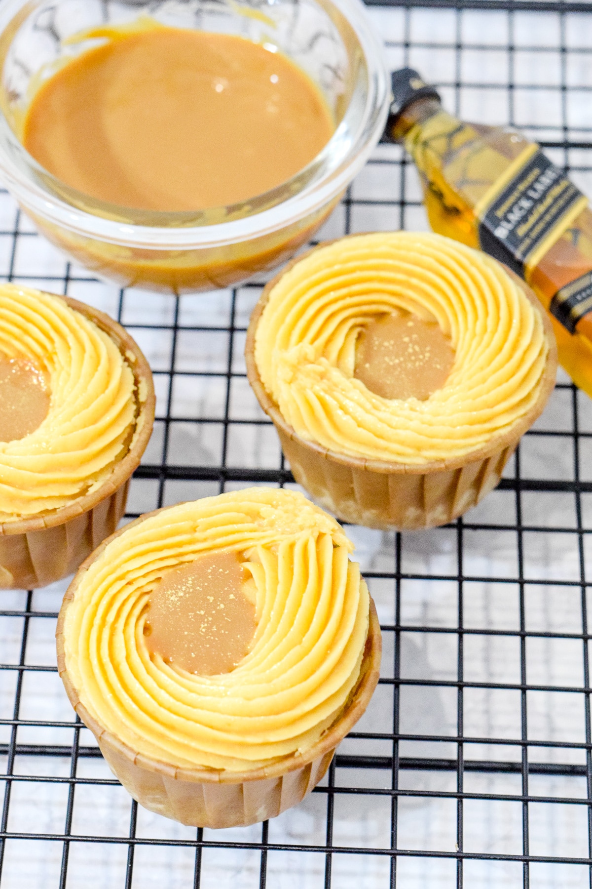 salted caramel whiskey cupcakes on a wire rack