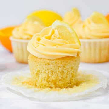 lemon cupcake with orange buttercream and a lemon slice