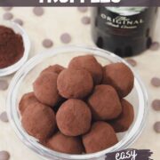 baileys irish cream chocolate truffles covered in cocoa powder in a bowl with a bottle of baileys.