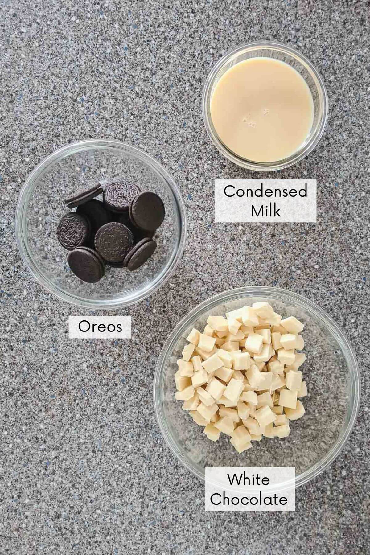 cookies and cream oreo fudge recipe ingredients in bowls with labels.