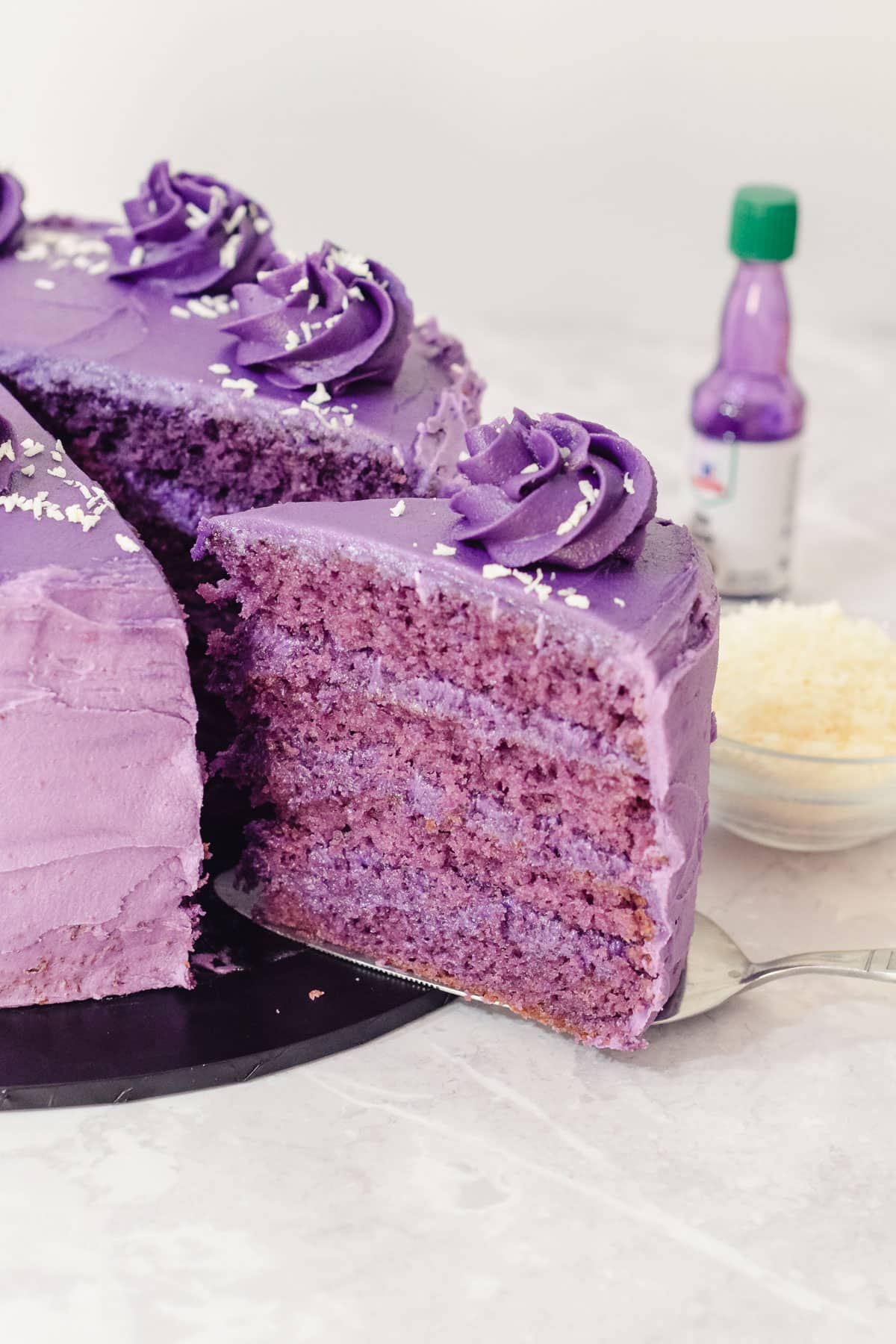 purple yam ube cake with four layers of ube sponge and an ube frosting and filling.