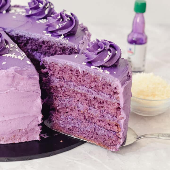 purple yam ube cake with four layers of ube sponge and an ube frosting and filling.