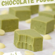 matcha green tea chocolate fudge squares with a bite taken out of it and white chocolate chips scattered