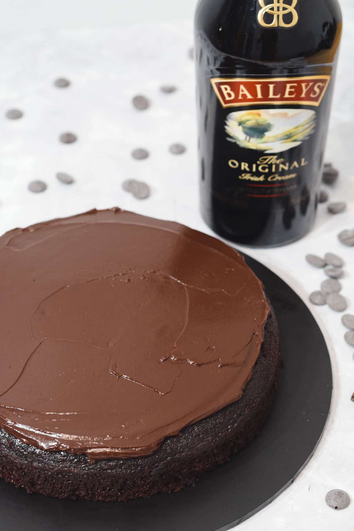baileys ganache frosting on a chocolate cake.