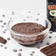 bailey irish cream chocolate ganache in a bowl with baileys and baking chocolate.