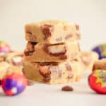 Creme egg blondies square slices with cadbury's Easter mini creme eggs and milk chocolate chips.