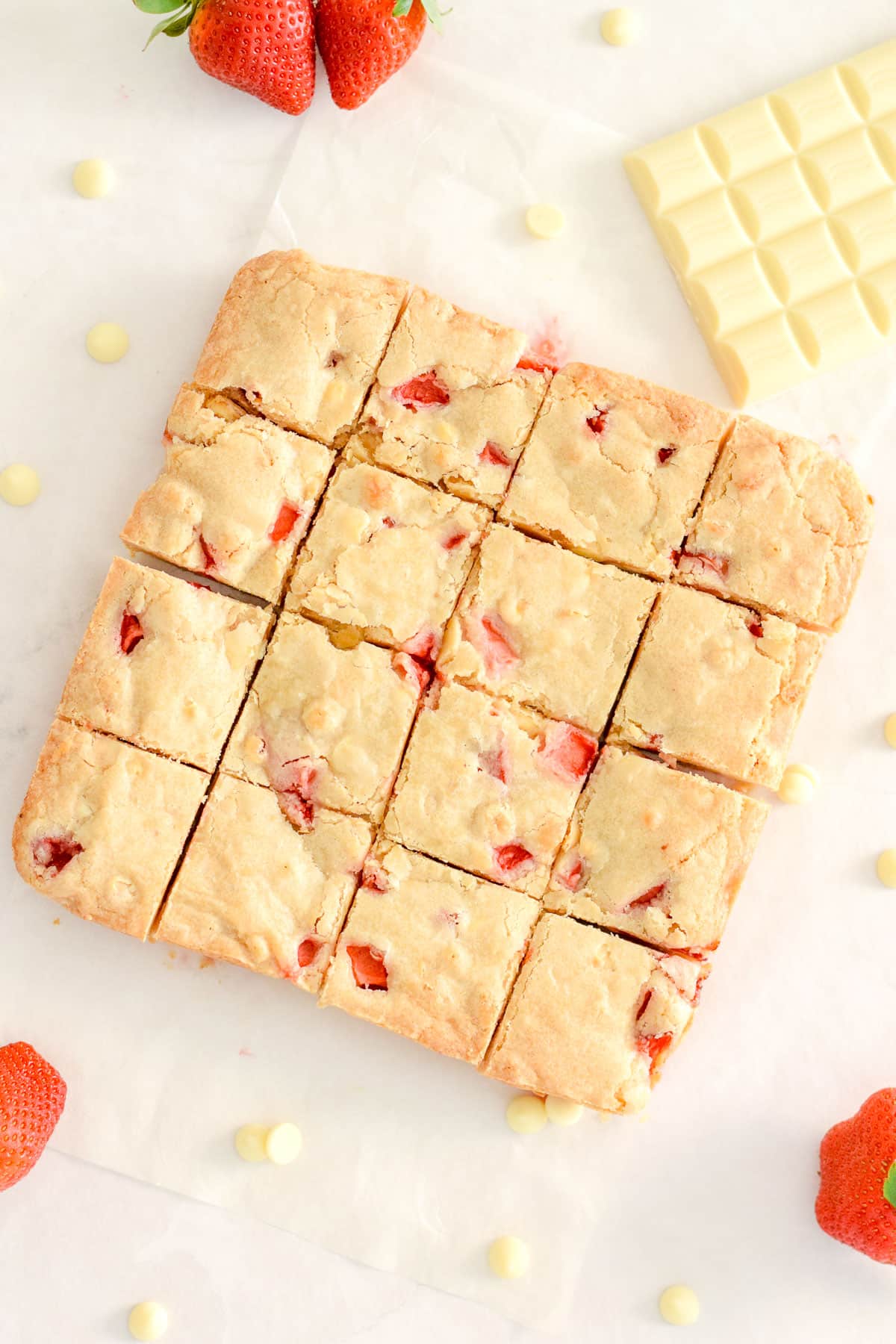 strawberry blondies squares with white chocolate chips and strawberries.