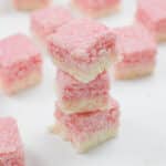 coconut ice squares stacked.