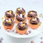 easter mini egg cupcakes with chocolate buttercream nests and mini eggs inside.